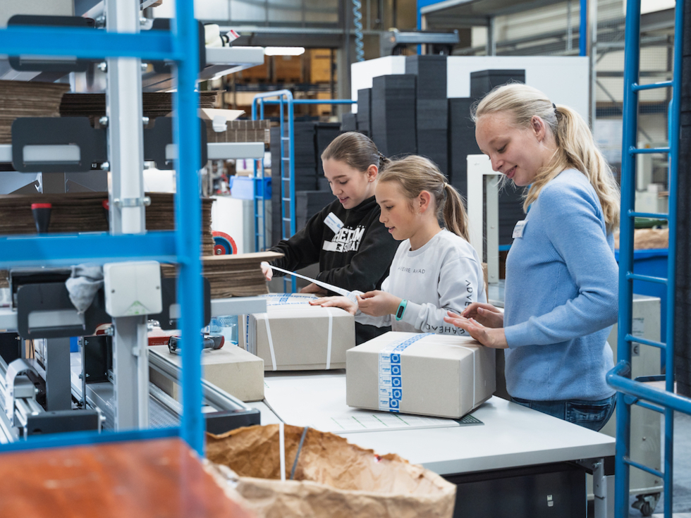 Drei Mädchen verpacken Pakete