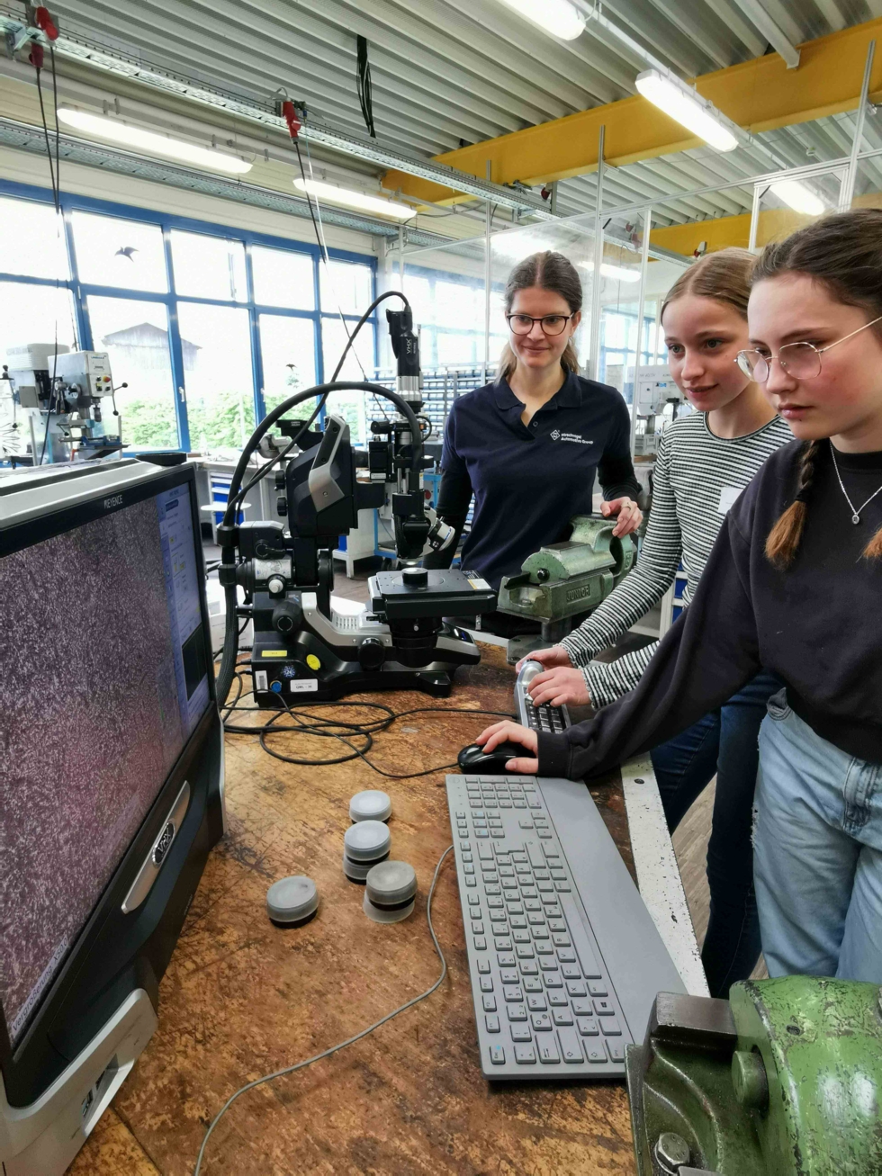 Die Girls'Day Teilnehmerinnen prüfen den Werkstoff mit dem Digitalmikroskop.