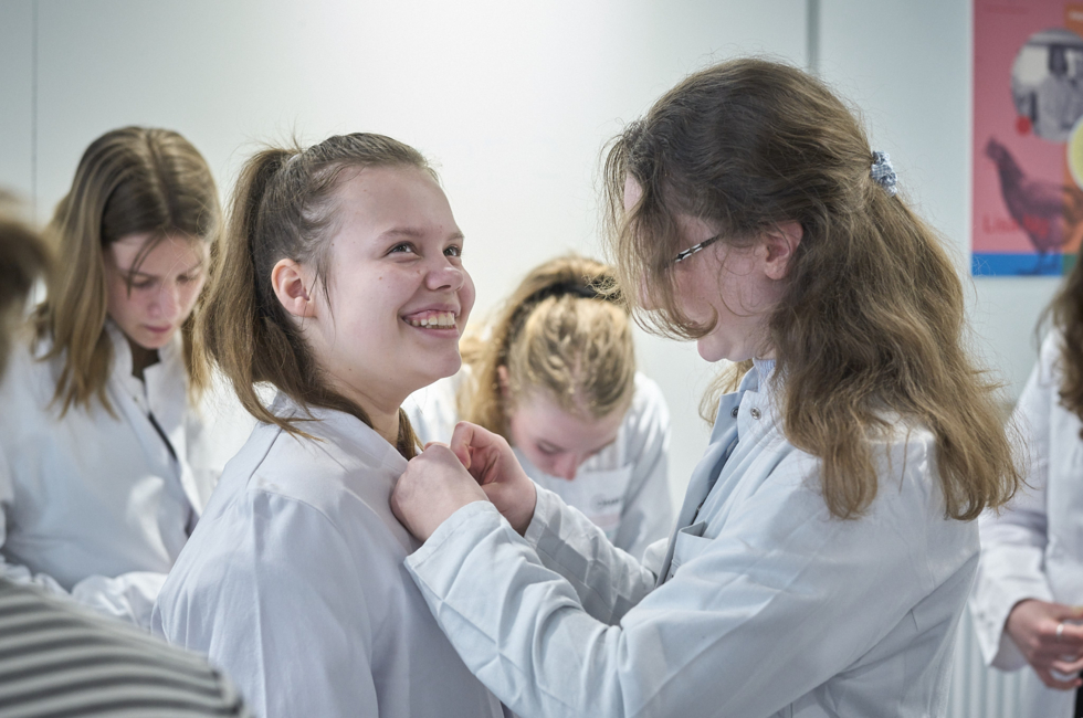 Girls'Day-Teilnehmerinnen in weißen Laborkitteln